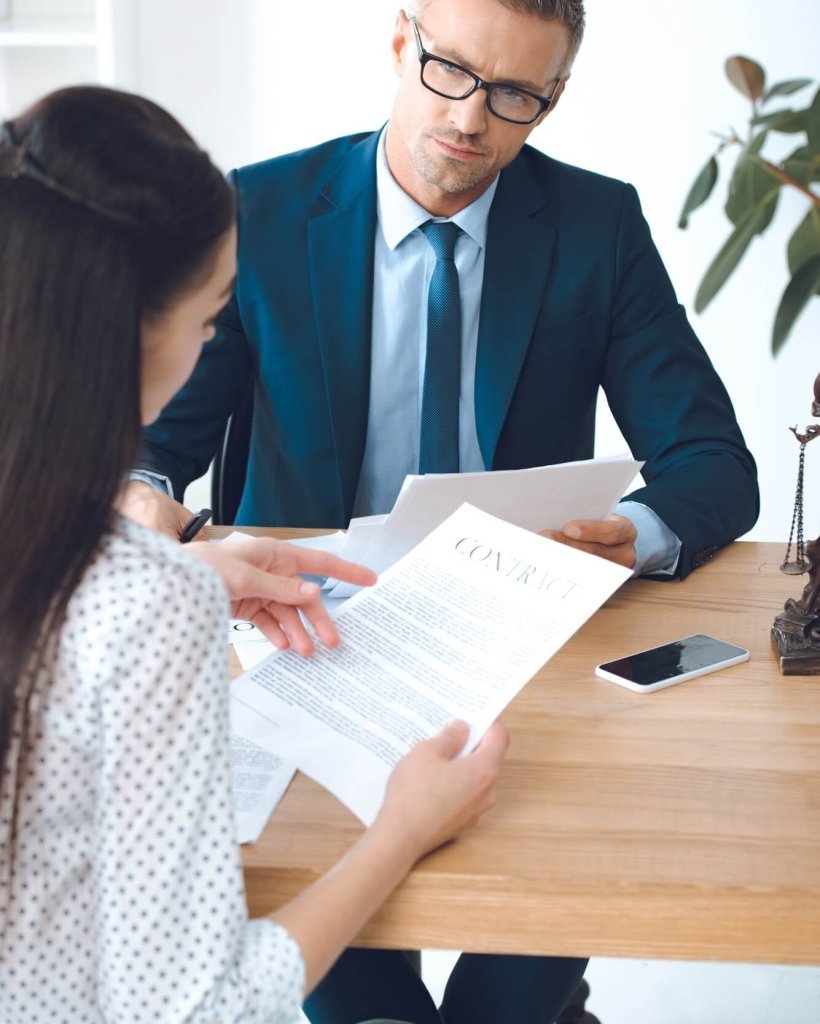 male-lawyer-looking-at-client-reading-contract.jpg male-lawyer-looking-at-client-reading-contract.jpg
